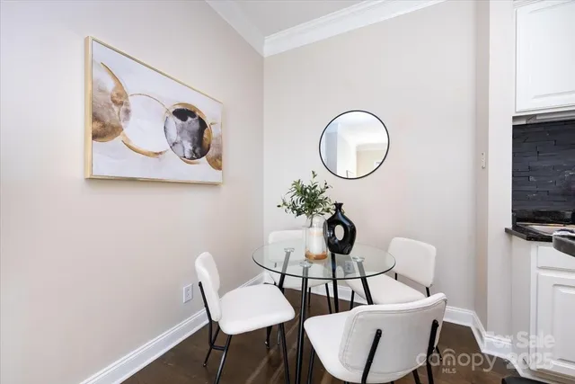 a dining room with wooden floor and a sink