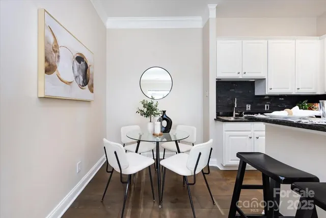 a view of kitchen with cabinets table and chairs