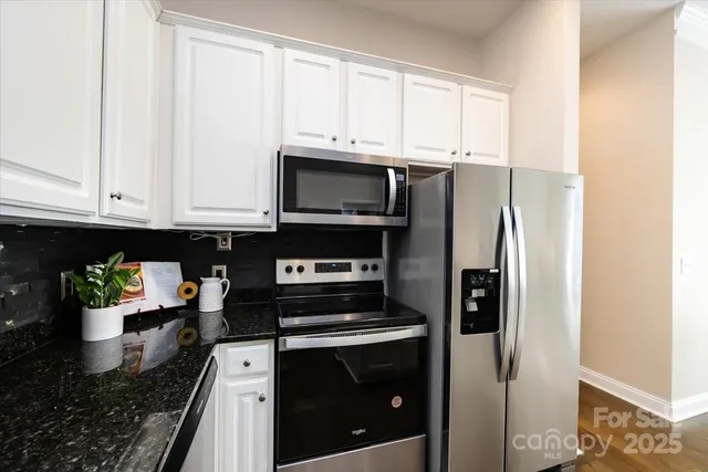 a kitchen that has a table and chairs in it