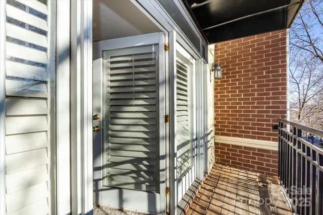 a view of a balcony with wooden fence and floor
