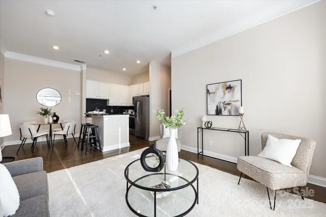 a dining room with furniture and wooden floor