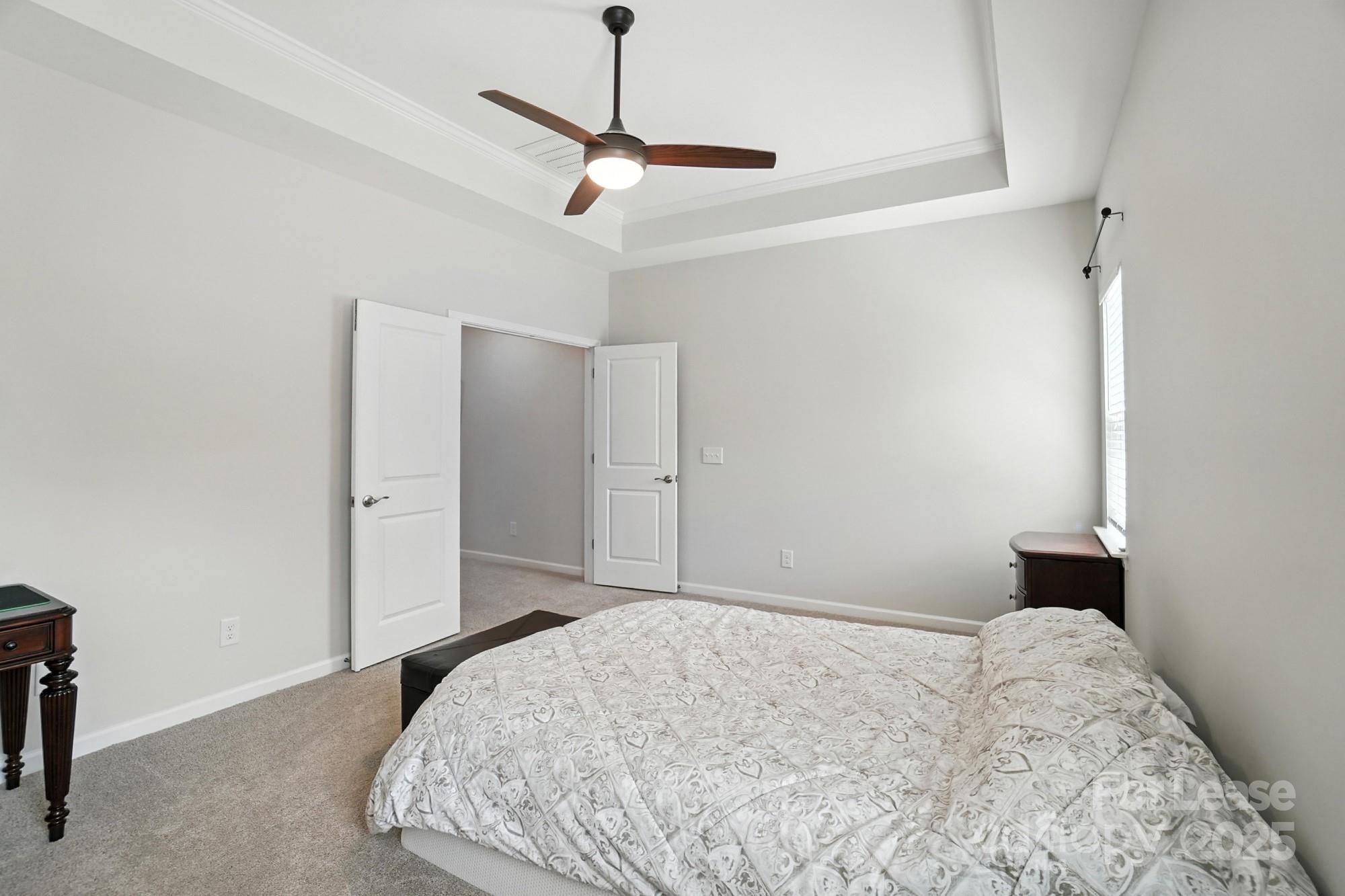 805 River Park Road Belmont, NC 28012 - Photo 23 of 42 a bedroom with a bed and a chandelier