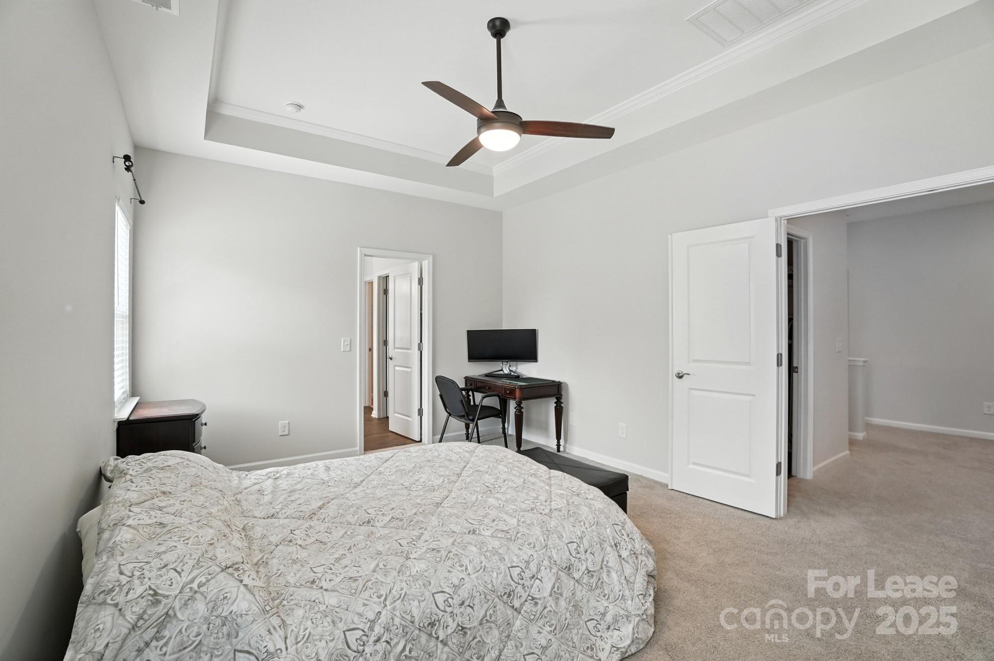 805 River Park Road Belmont, NC 28012 - Photo 24 of 42 a bedroom with a bed and a chandelier