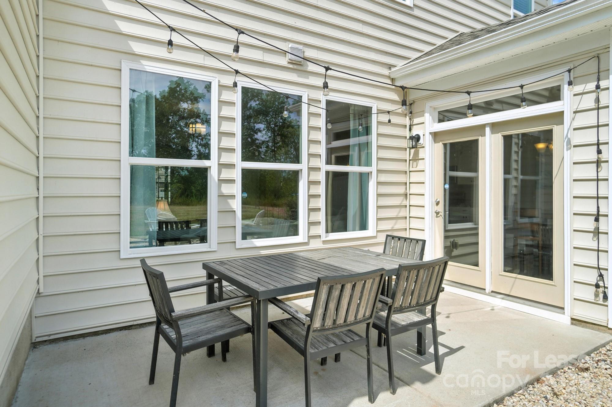 805 River Park Road Belmont, NC 28012 - Photo 41 of 42 a patio with table and chairs and potted plants
