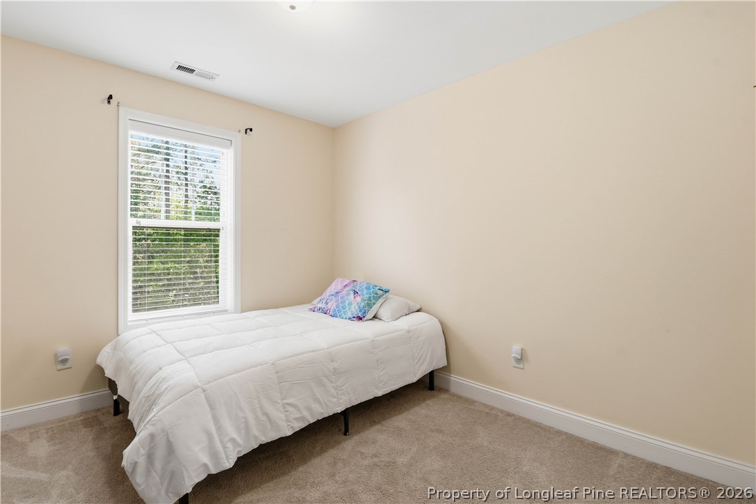 140 Birch Avenue Spring Lake, NC 28390 - Photo 36 of 49 a bedroom with a bed and a window