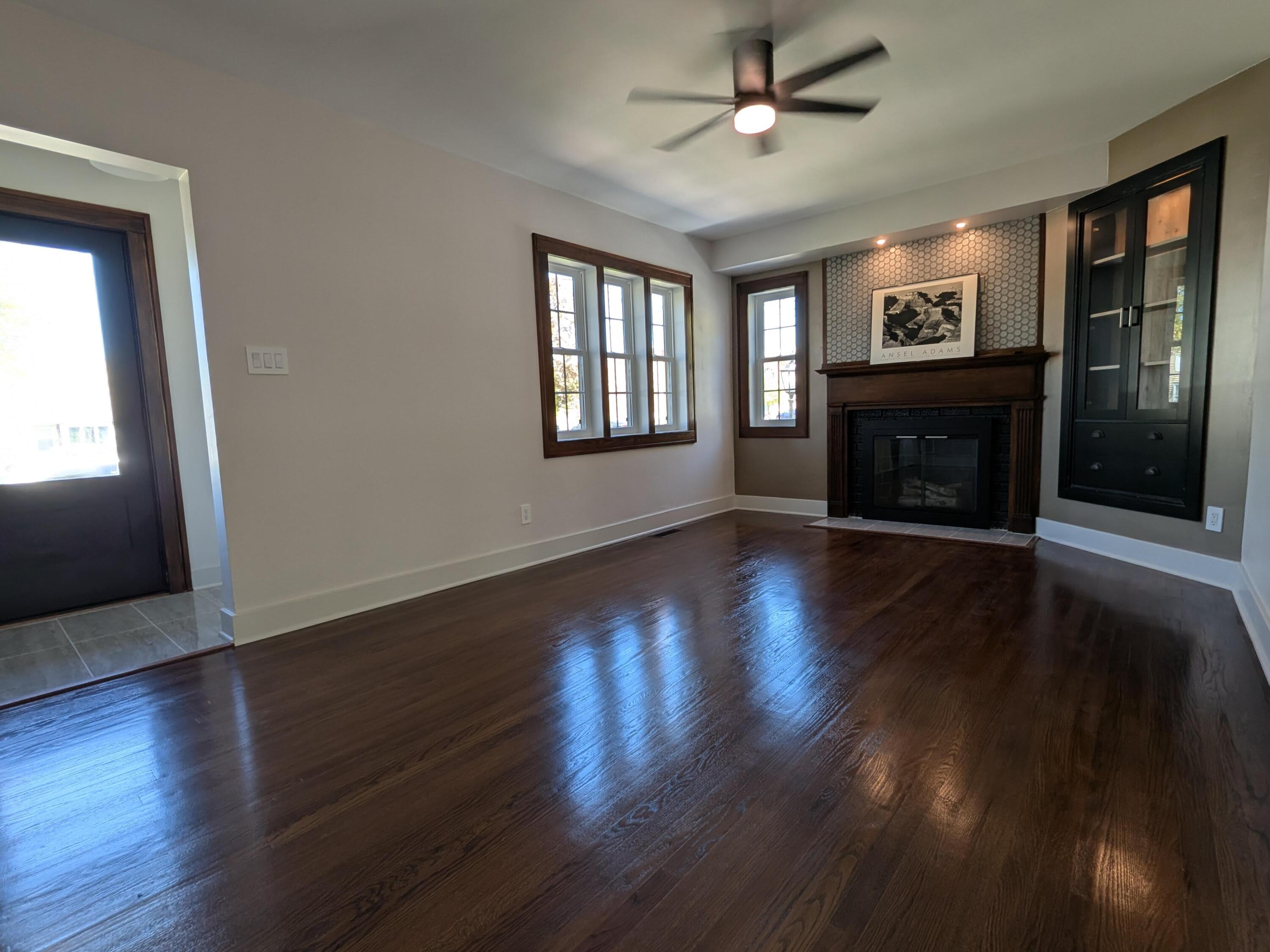 3298 Ridge Road Highland, IN 46322 - Photo 18 of 39 a view of an empty room with wooden floor fireplace and a window