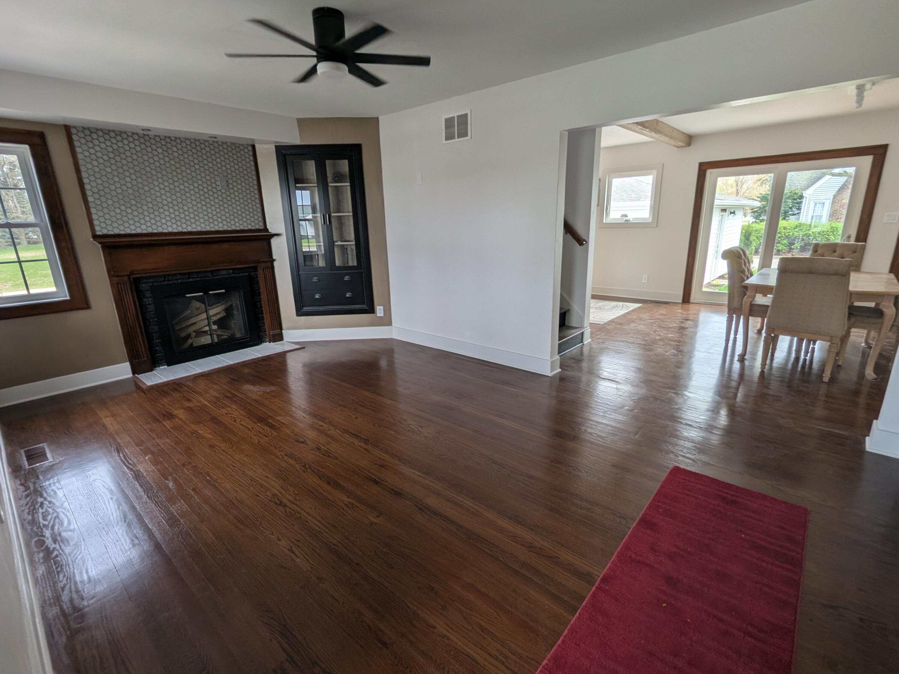 3298 Ridge Road Highland, IN 46322 - Photo 19 of 39 an empty room with wooden floor fireplace and windows
