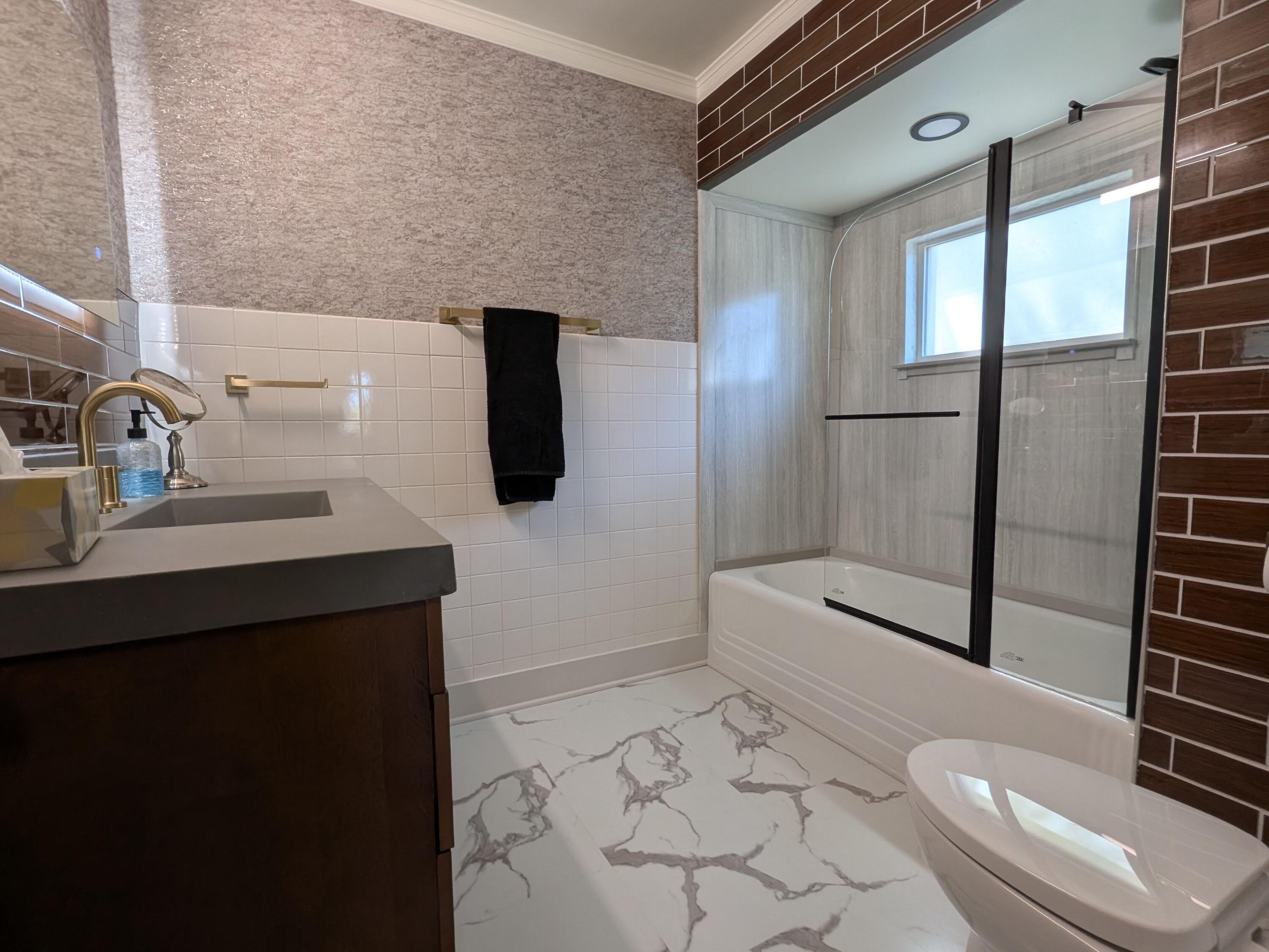3298 Ridge Road Highland, IN 46322 - Photo 20 of 39 a bathroom with a sink a toilet and shower