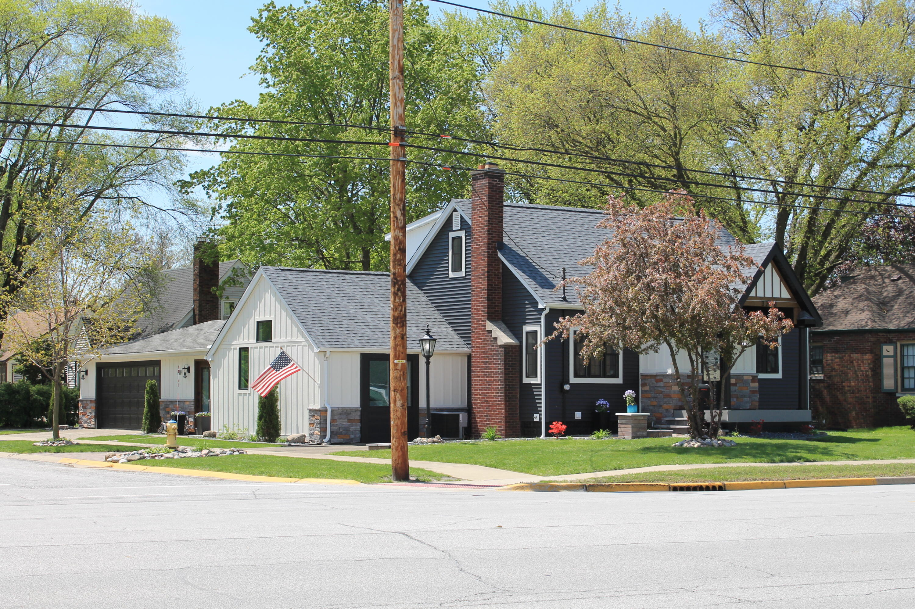 3298 Ridge Road Highland, IN 46322 - Photo 2 of 39 a view of a white house with a yard and large trees