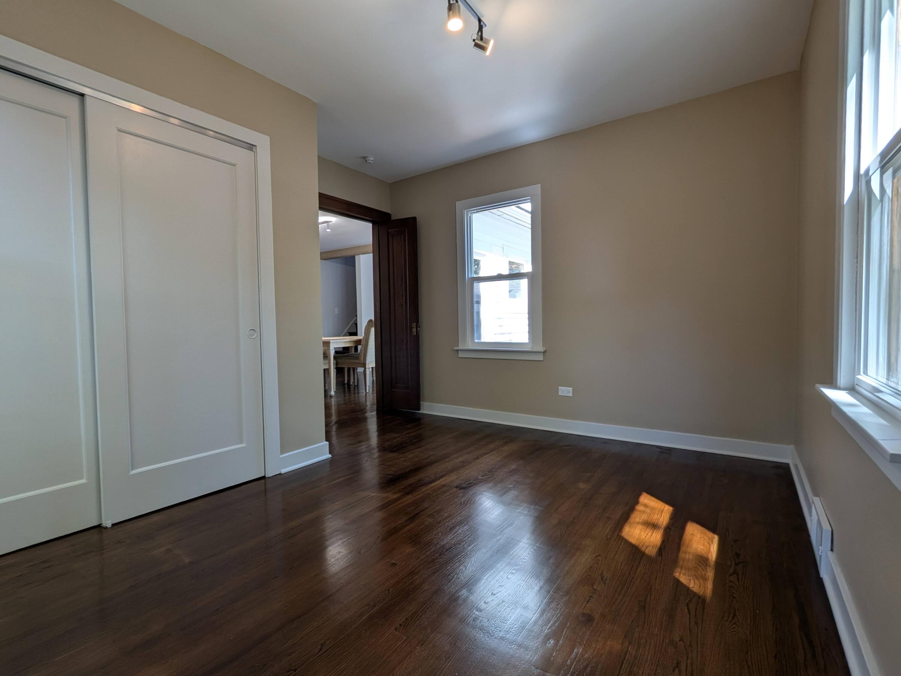 3298 Ridge Road Highland, IN 46322 - Photo 23 of 39 an empty room with wooden floor and windows