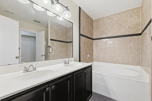 a bathroom with a bathtub and shower