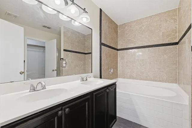 a bathroom with a bathtub and shower