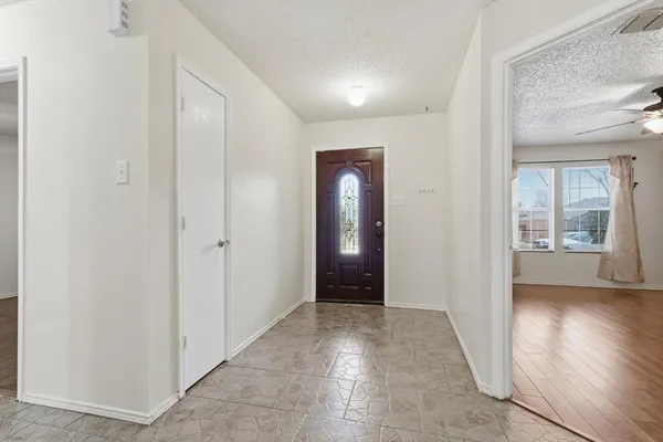 an empty room with closet and a window