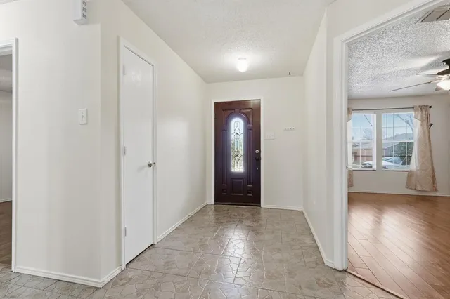 an empty room with closet and a window