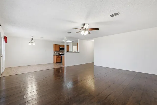 a large kitchen with kitchen island granite countertop a sink cabinets and stainless steel appliances