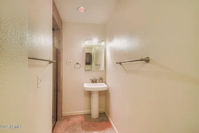 a bathroom with a sink and a mirror