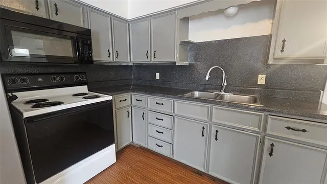 a kitchen with stainless steel appliances granite countertop a refrigerator sink and cabinets