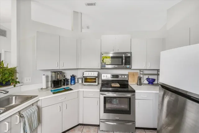 a large white kitchen with a window