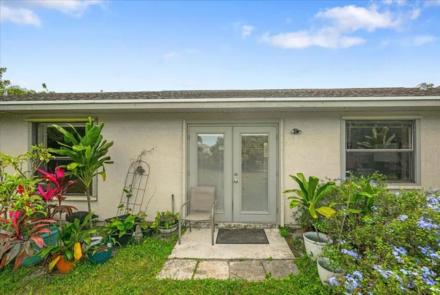 a bedroom with a bed a bookshelf and a large mirror