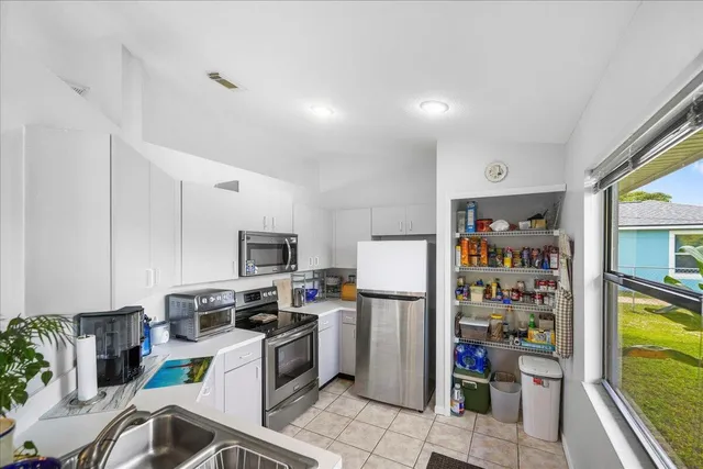 a kitchen with a refrigerator and a sink