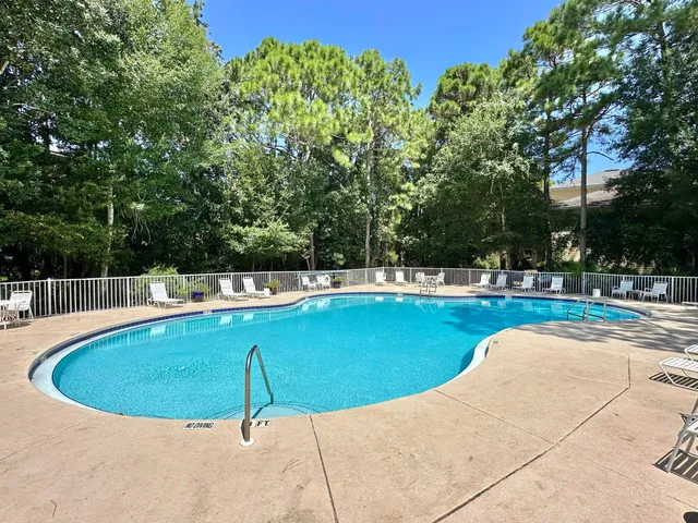 a view of a swimming pool with a yard