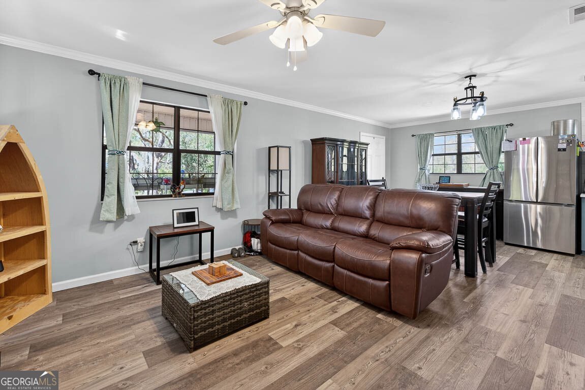 33 Warren Avenue Waverly, GA 31565 - Photo 2 of 63 a living room with furniture a flat screen tv and windows
