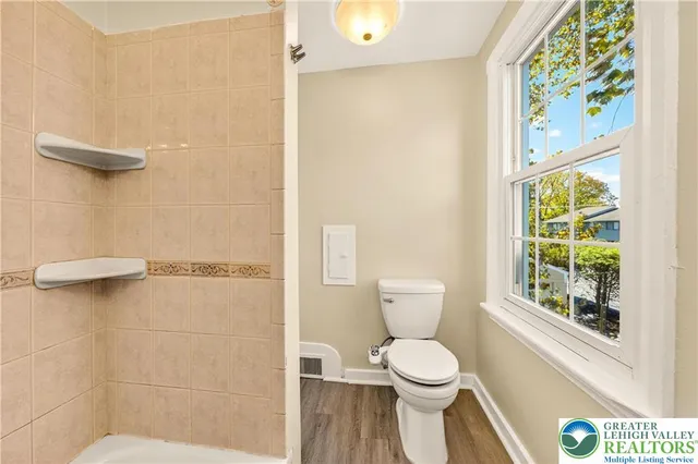 a bathroom with a toilet and a shower