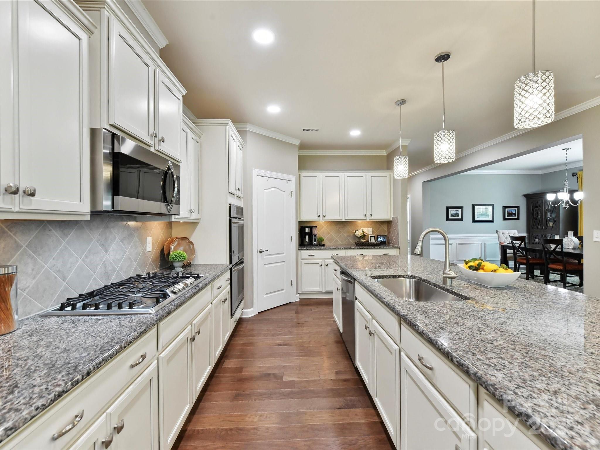2972 Arches Bluff Circle Lancaster, SC 29720 - Photo 15 of 47 a large kitchen with stainless steel appliances granite countertop a stove and a sink