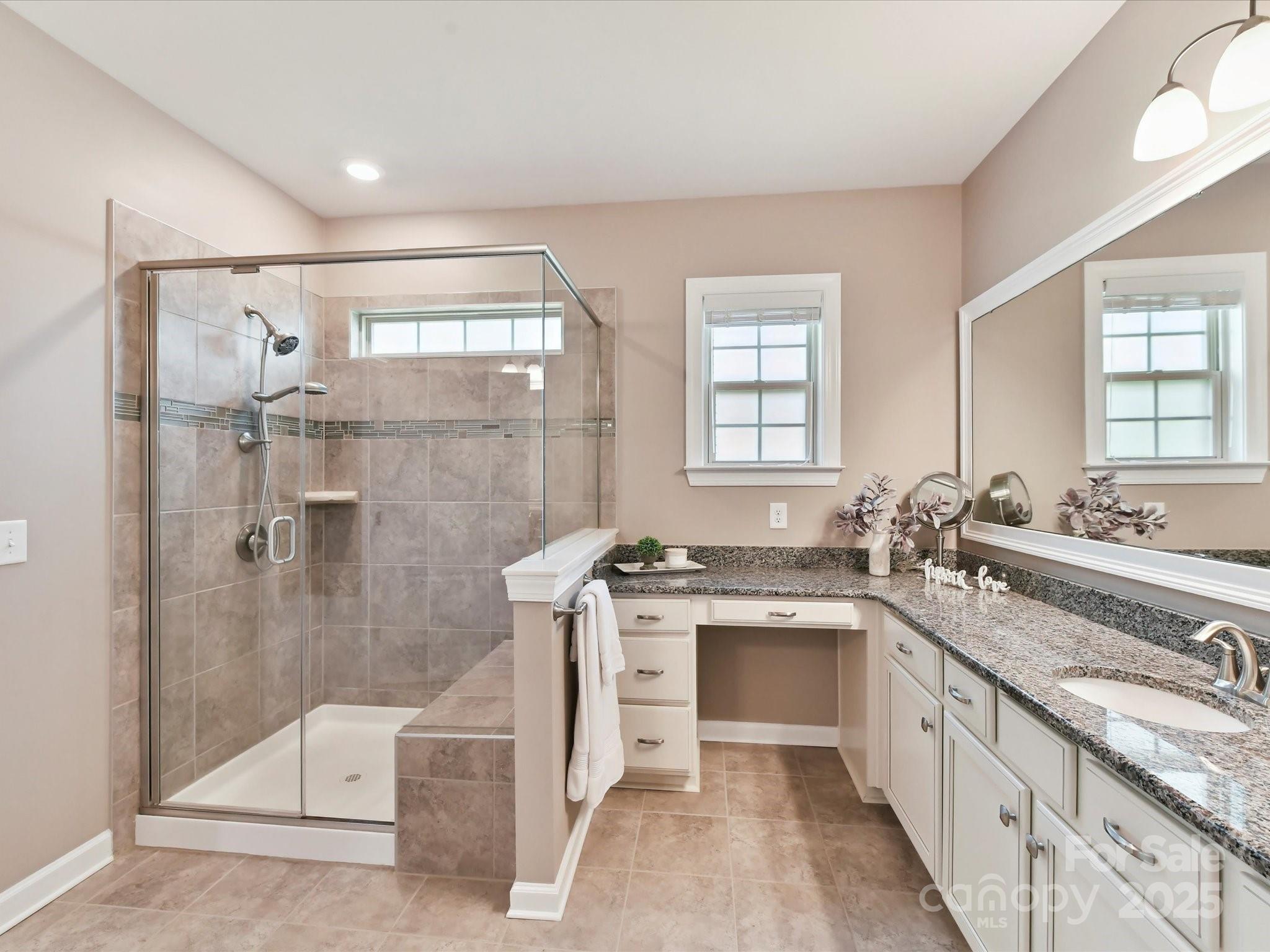 2972 Arches Bluff Circle Lancaster, SC 29720 - Photo 22 of 47 a spacious bathroom with a granite countertop sink a toilet a mirror and shower