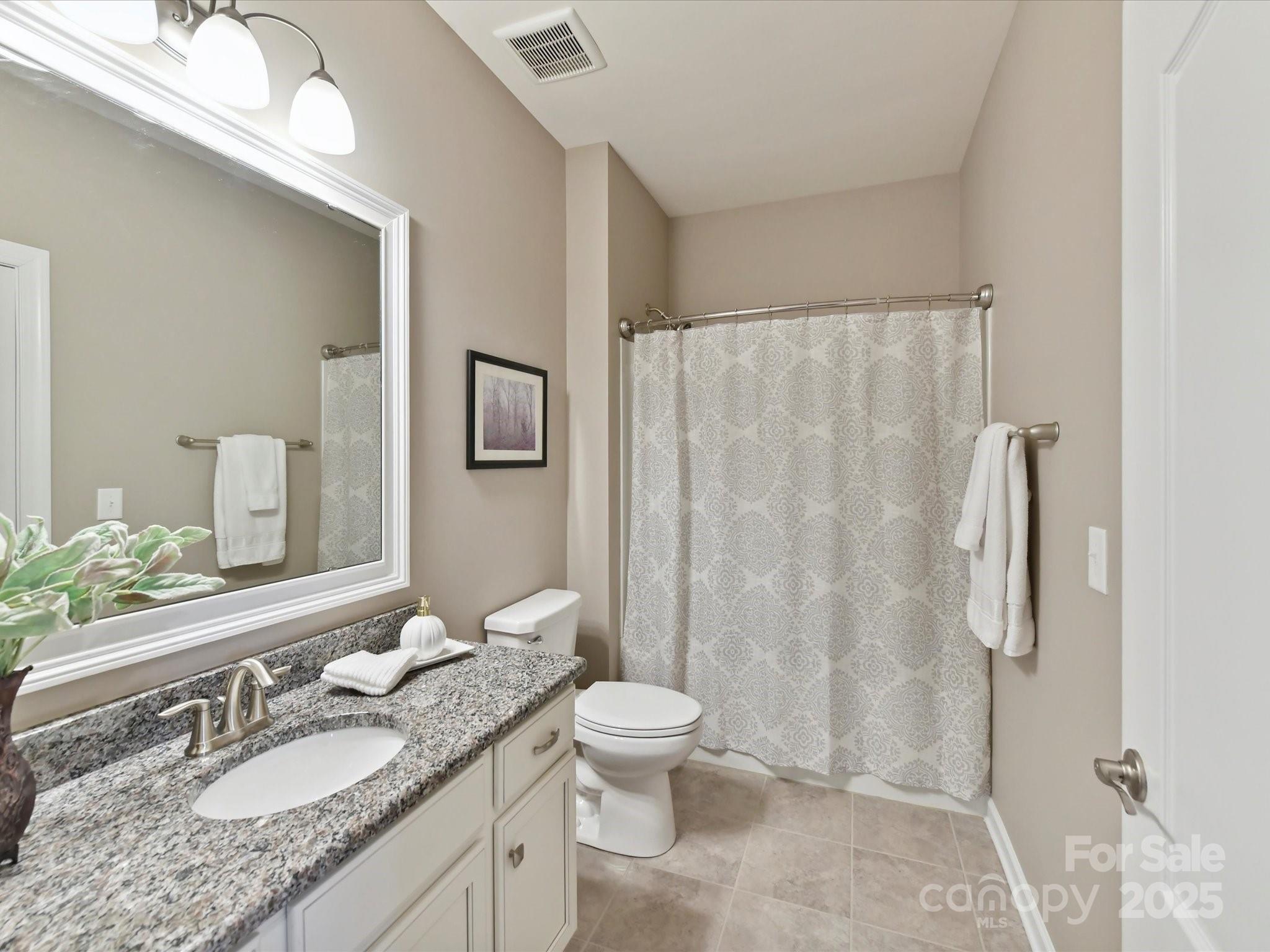 2972 Arches Bluff Circle Lancaster, SC 29720 - Photo 27 of 47 a bathroom with a granite countertop sink toilet and shower