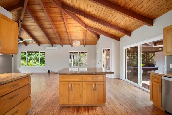 a view of a kitchen with kitchen island a counter tops and a wooden floors