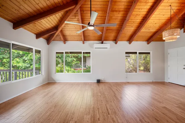 a view of room with window and wooden floor