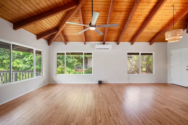 a view of room with window and wooden floor