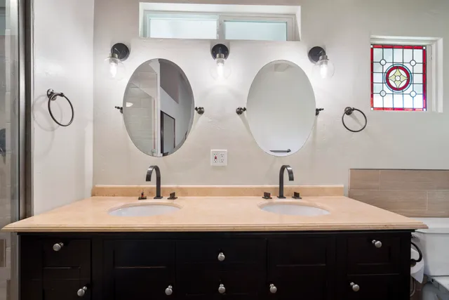 a bathroom with a double vanity sink and a mirror