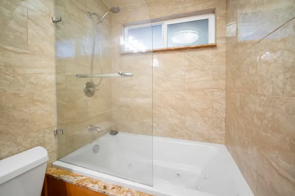a bathroom with a tub and a shower