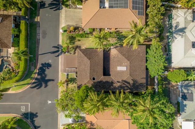 front view of a house with a yard and potted plants
