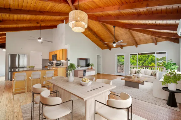 a view of a dining room with furniture a chandelier and wooden floor