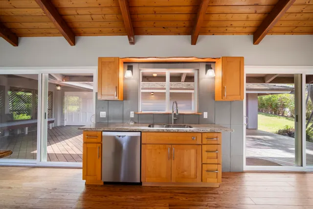 a kitchen with lots of counter top space and wooden floor