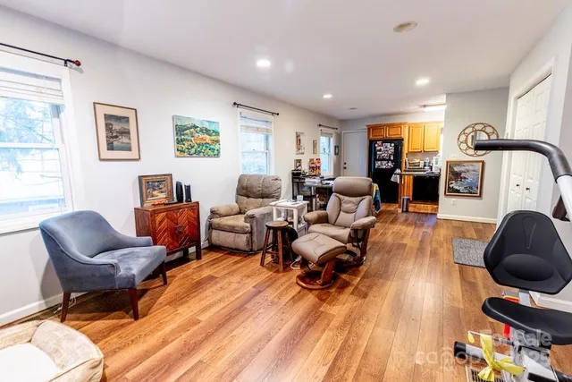 a living room with furniture and a wooden floor