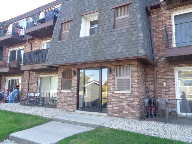 a front view of a house with a garden and plants