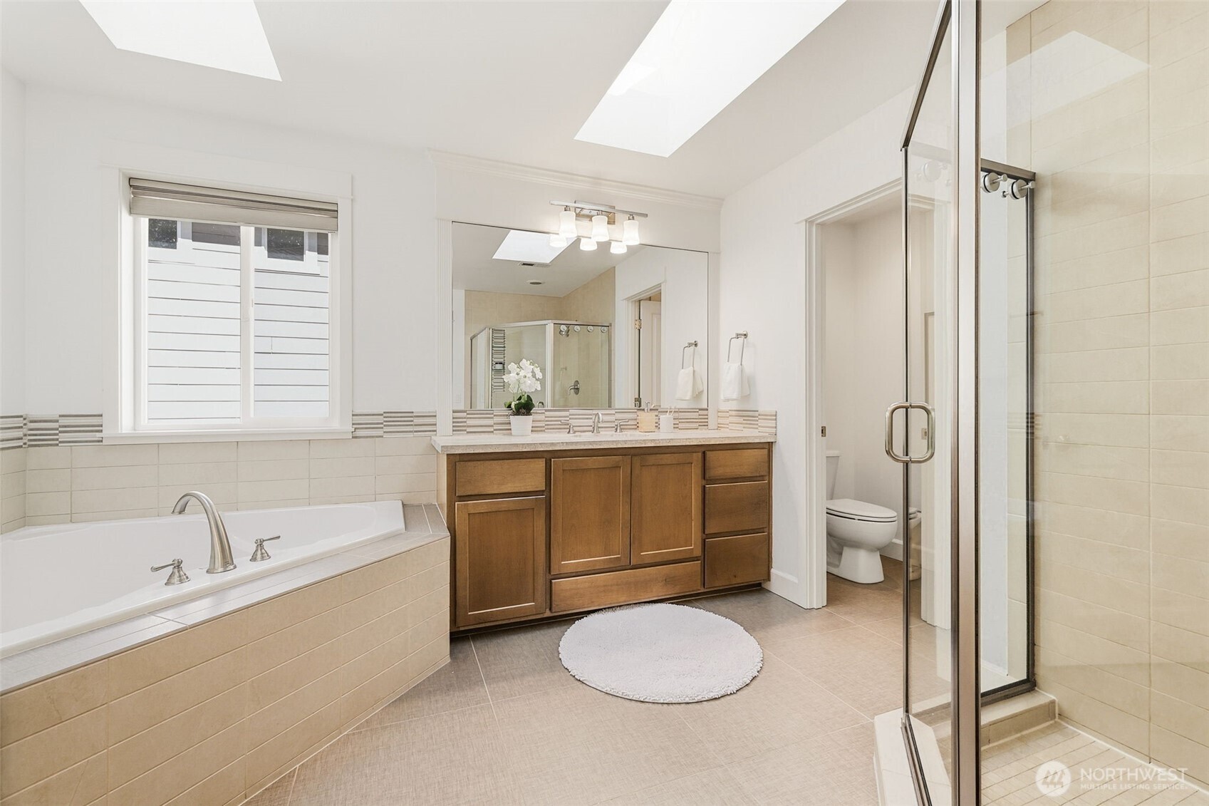 1737 Mt Baker Avenue Northeast Renton, WA 98059 - Photo 22 of 40 a bathroom with a tub sink toilet and mirror