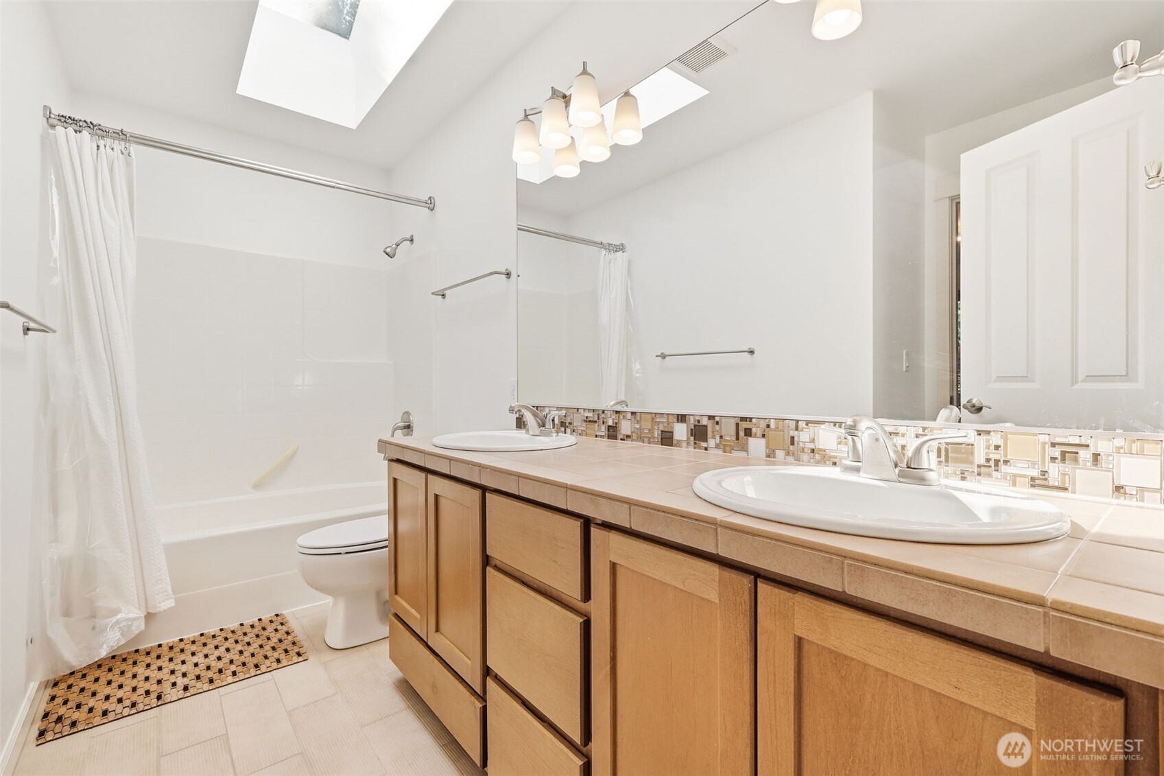 1737 Mt Baker Avenue Northeast Renton, WA 98059 - Photo 25 of 40 a bathroom with a double vanity sink and a mirror