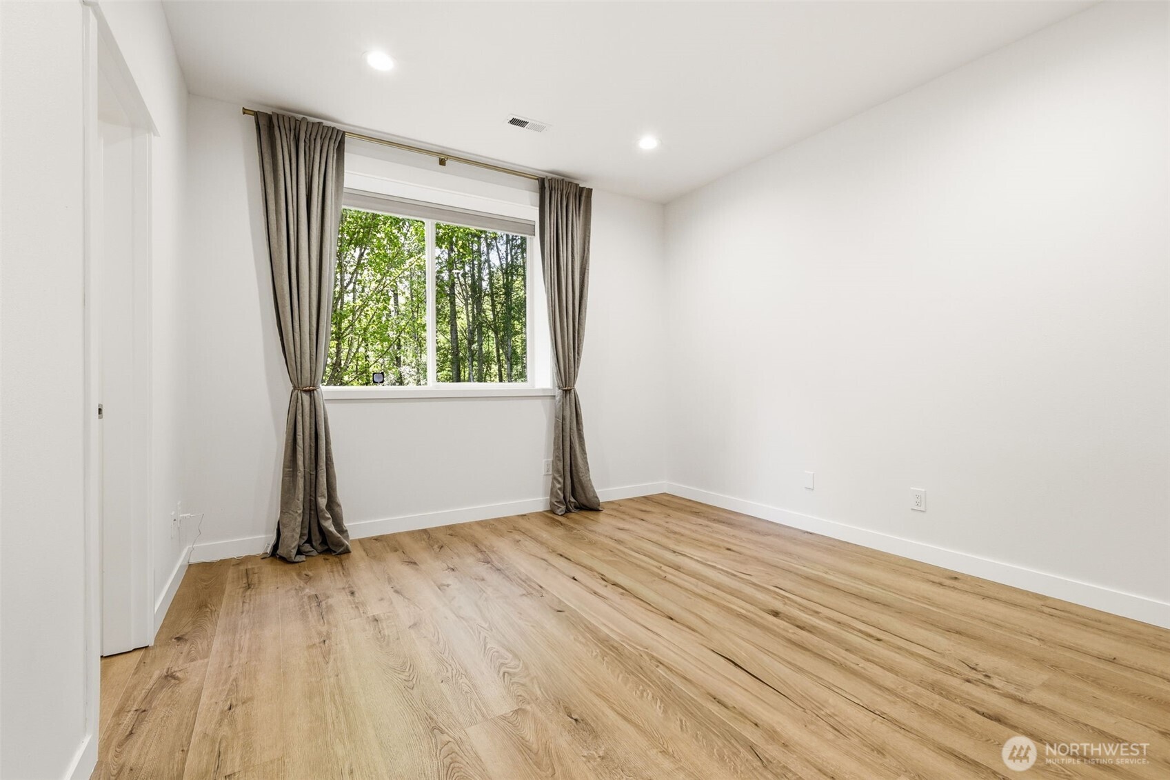 1737 Mt Baker Avenue Northeast Renton, WA 98059 - Photo 33 of 40 an empty room with wooden floor and windows
