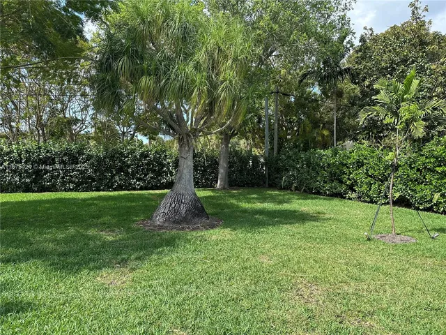 a view of garden with wooden fence