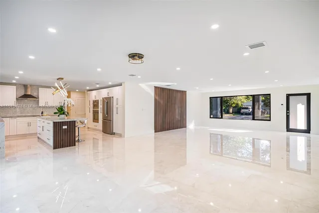a view of kitchen with stainless steel appliances refrigerator sink and cabinets