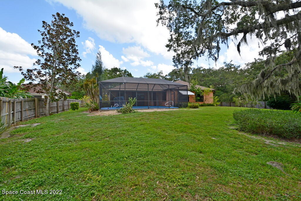 3190 Aurora Road Melbourne, FL 32934 - Photo 27 of 33 a view of a house with a back yard