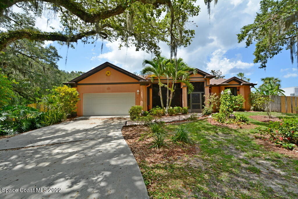 3190 Aurora Road Melbourne, FL 32934 - Photo 3 of 33 a front view of a house with a garden