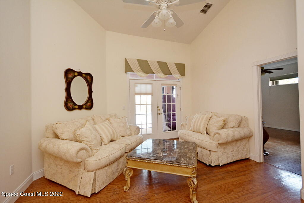3190 Aurora Road Melbourne, FL 32934 - Photo 8 of 33 a living room with furniture a desk and chair