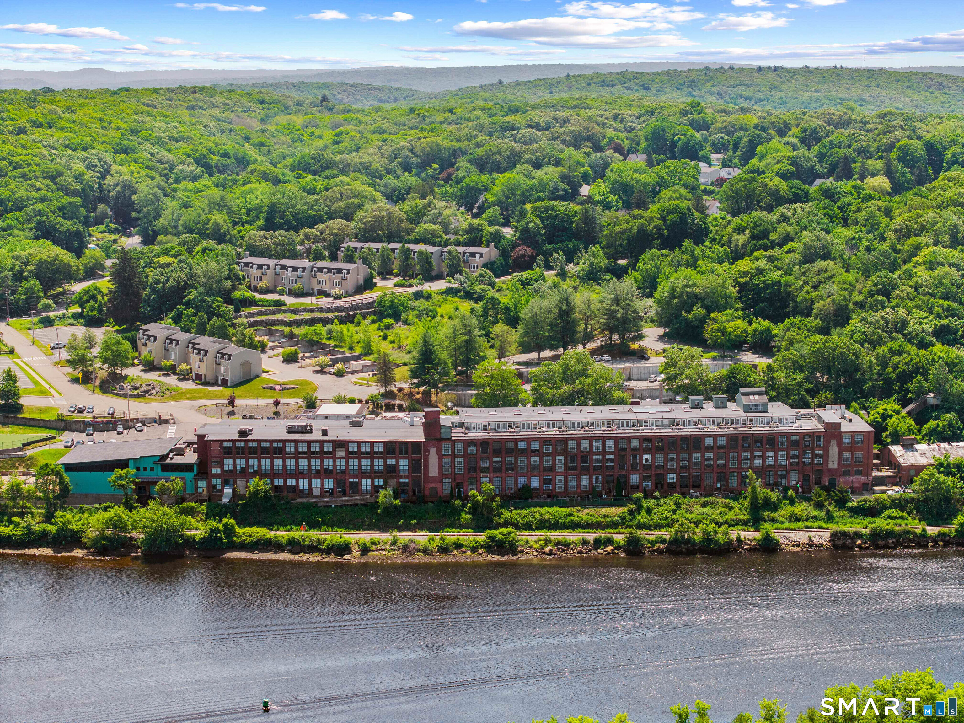 68 Thermos Avenue, Unit 110A Norwich, CT 06360 - Photo 2 of 39 a view of a garden with a bench in wooden floor