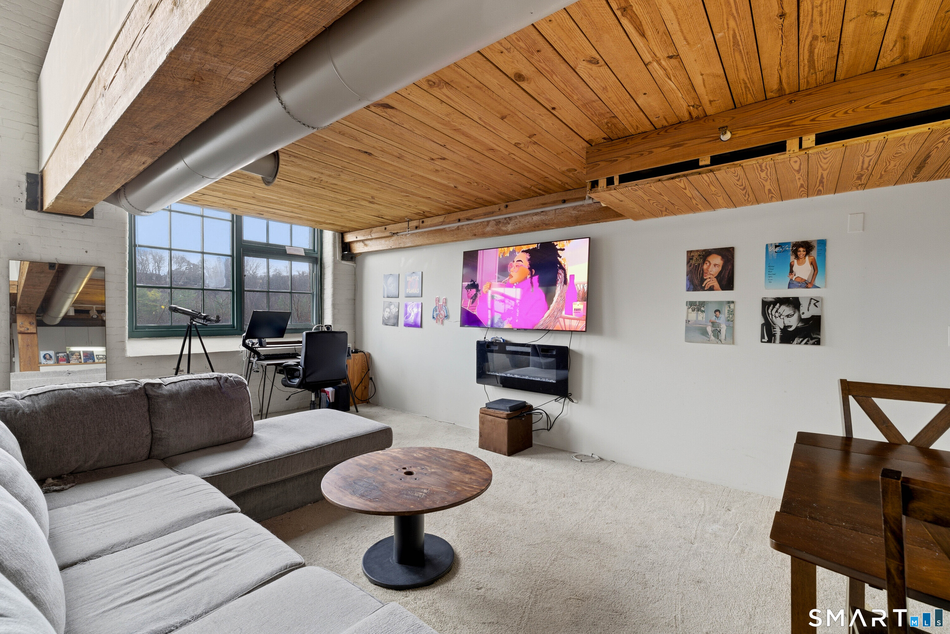 68 Thermos Avenue, Unit 110A Norwich, CT 06360 - Photo 23 of 39 a living room with furniture and a flat screen tv